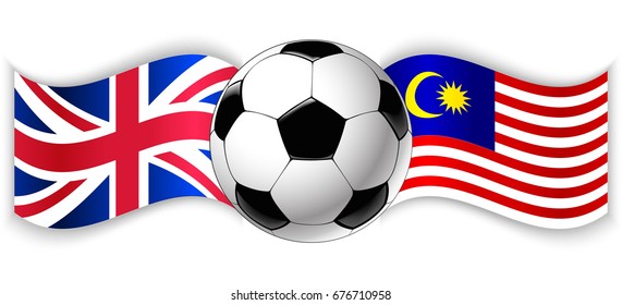 British and Malaysian wavy flags with football ball. United Kingdom combined with Malaysia isolated on white. Football match or international sport competition concept.