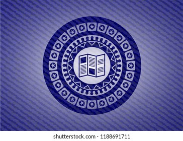 brochure icon inside emblem with denim texture