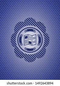 brochure icon inside emblem with jean background