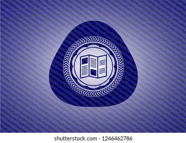 brochure icon inside jean or denim emblem or badge background
