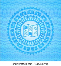 brochure icon inside sky blue water wave badge background.