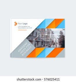 Brochure layout of the template cover design annual report, a magazine with a blue and orange triangles and stripes, with logo and space for photo and text. Vector illustration of a modern flat style.