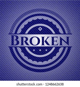 Broken badge with denim background