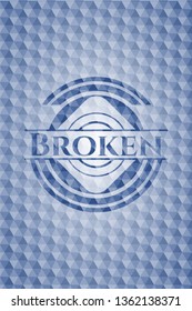 Broken blue emblem with geometric pattern.