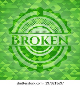Broken green emblem. Mosaic background