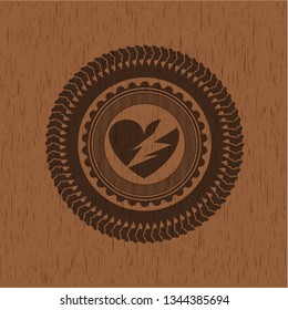 broken heart icon inside badge with wood background