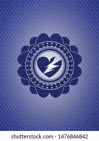 broken heart icon inside badge with denim background