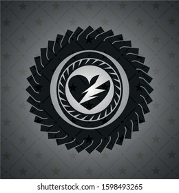 broken heart icon inside black emblem
