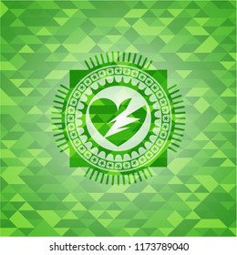 broken heart icon inside green emblem. Mosaic background