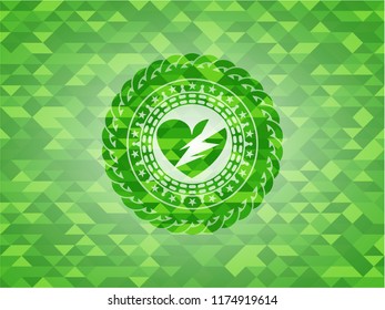 broken heart icon inside green mosaic emblem