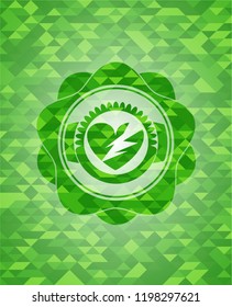 broken heart icon inside green mosaic emblem