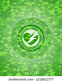 broken heart icon inside green mosaic emblem