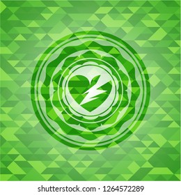 broken heart icon inside green emblem with triangle mosaic background