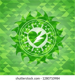 broken heart icon inside green mosaic emblem