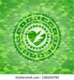 broken heart icon inside green emblem with mosaic background