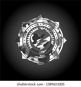 broken heart icon inside grey camo emblem