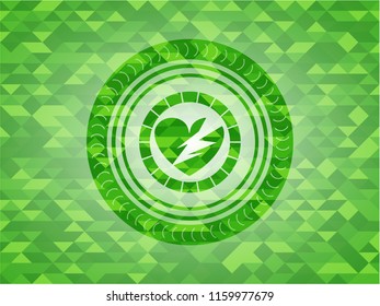 broken heart icon inside realistic green mosaic emblem