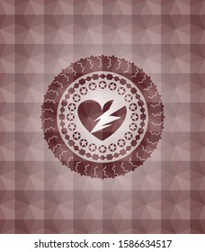 broken heart icon inside red seamless emblem or badge with abstract geometric pattern background.