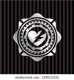 broken heart icon inside silvery emblem