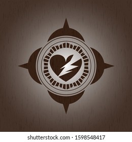 broken heart icon inside wood badge or emblem