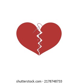 broken heart with sewing threads on a white background