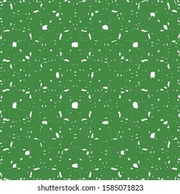 Broken white drops on a green surface. Decorative flecked background. Wallpaper texture. Wrapping paper.