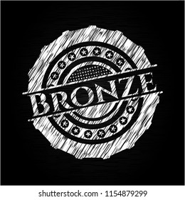 Bronze chalkboard emblem written on a blackboard