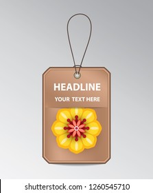 Bronze tag with string and yellow flower.