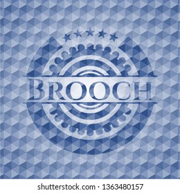 Brooch blue emblem with geometric pattern background.