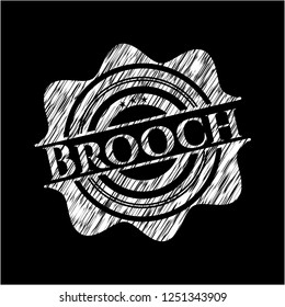 Brooch on chalkboard