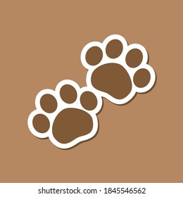 Brown animal paw print set sticker patch print design with white border outline on brown background. Simple flat vector illustration.