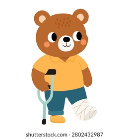 A brown bear character standing and facing forward, isolated on a white background. The animal is depicted as an injured patient, wearing a yellow shirt and blue trousers with one yellow shoe. Its left leg is covered in a white plaster cast bandage, and its right paw holds a teal crutch with a black handle.