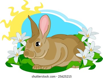 Brown bunny sitting in the grass surrounded with flowers