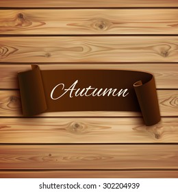 Brown, curved paper banner, on wooden planks. Autumn background. Vector illustration.