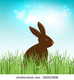 Brown Cute Chocolate bunny in grass.  Happy easter banner