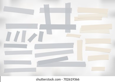 Brown and gray different size adhesive, sticky, tape, paper pieces.