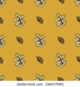 Brown and green leaves seamless pattern on a golden background.