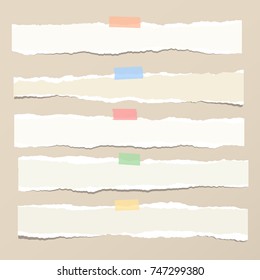 Brown horizontal ripped strips, notebook, note paper for text or message stuck with colorful sticky tape on brown background.