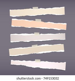 Brown horizontal ripped strips, notebook, note paper for text or message stuck with sticky tape on dark gray background.