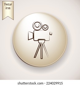 Brown icon on the round button with shadow. Vector icon camcorder