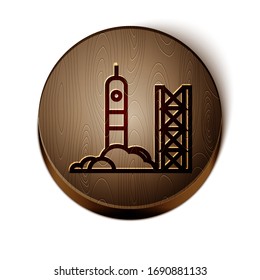 Brown line Rocket launch from the spaceport icon isolated on white background. Launch rocket in space. Wooden circle button. Vector Illustration