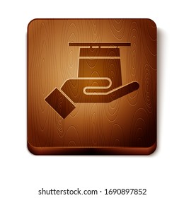 Brown Magician hat in hand icon isolated on white background. Magic trick. Mystery entertainment concept. Wooden square button. Vector Illustration