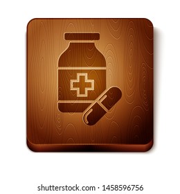 Brown Medicine bottle and pills icon isolated on white background. Bottle pill sign. Pharmacy design. Wooden square button. Vector Illustration