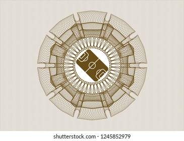 Brown money style emblem or rosette with football field icon inside