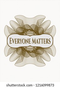 Brown money style rosette with text Everyone Matters inside
