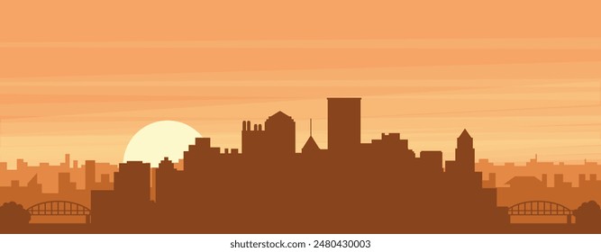 Brown panoramic poster of the city skyline with misty background buildings, sunrise, clouds and mountains of PITTSBURGH, UNITED STATES