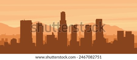 Brown panoramic poster of the city skyline with misty background buildings, sunrise, clouds and mountains of LOS ANGELES, UNITED STATES