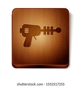 Brown Ray gun icon isolated on white background. Laser weapon. Space blaster. Wooden square button. Vector Illustration