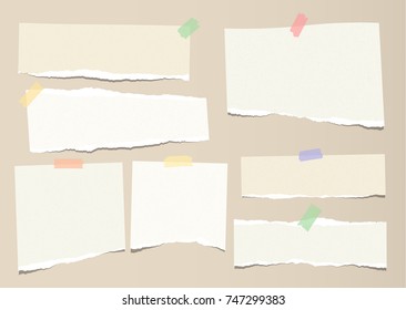 Brown ripped strips, notebook, note paper for text or message stuck with colorful sticky tape on brown background.