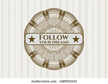 Brown rosette or money style emblem with text Follow your dreams inside